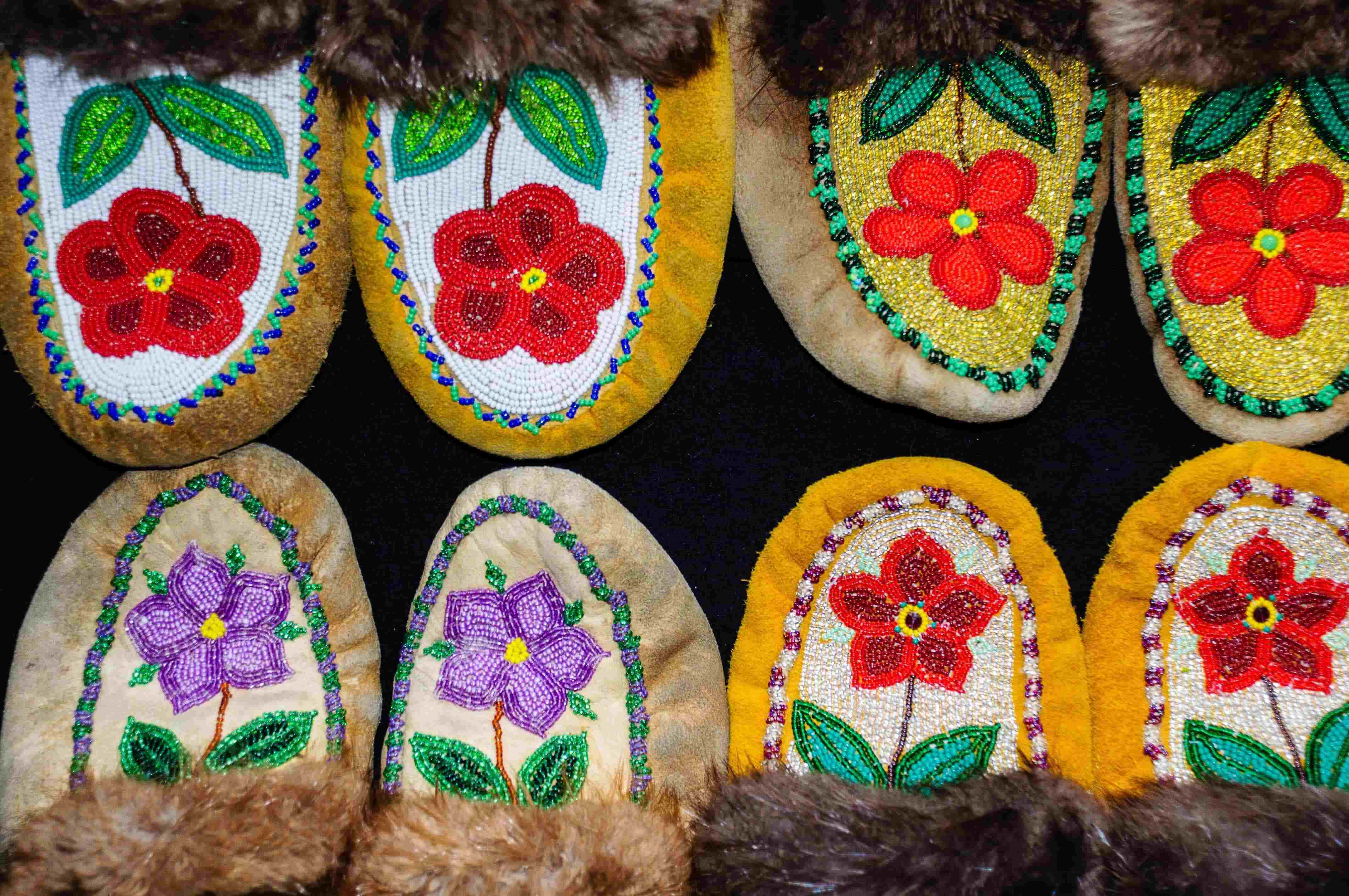 four pairs of beaded slippers