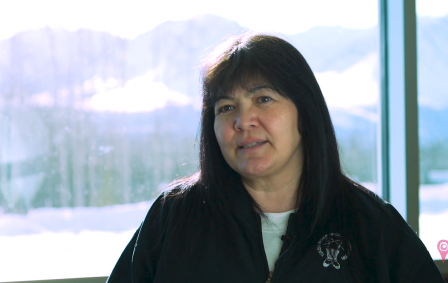 Indigenous woman from the Yukon wearing black jacket with Champagne and Aishihik First Nations logo