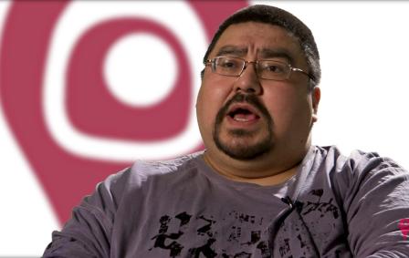 Indigenous man with a goatee wearing glasses 