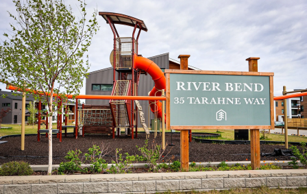 A sign with an address on it in front of a playground