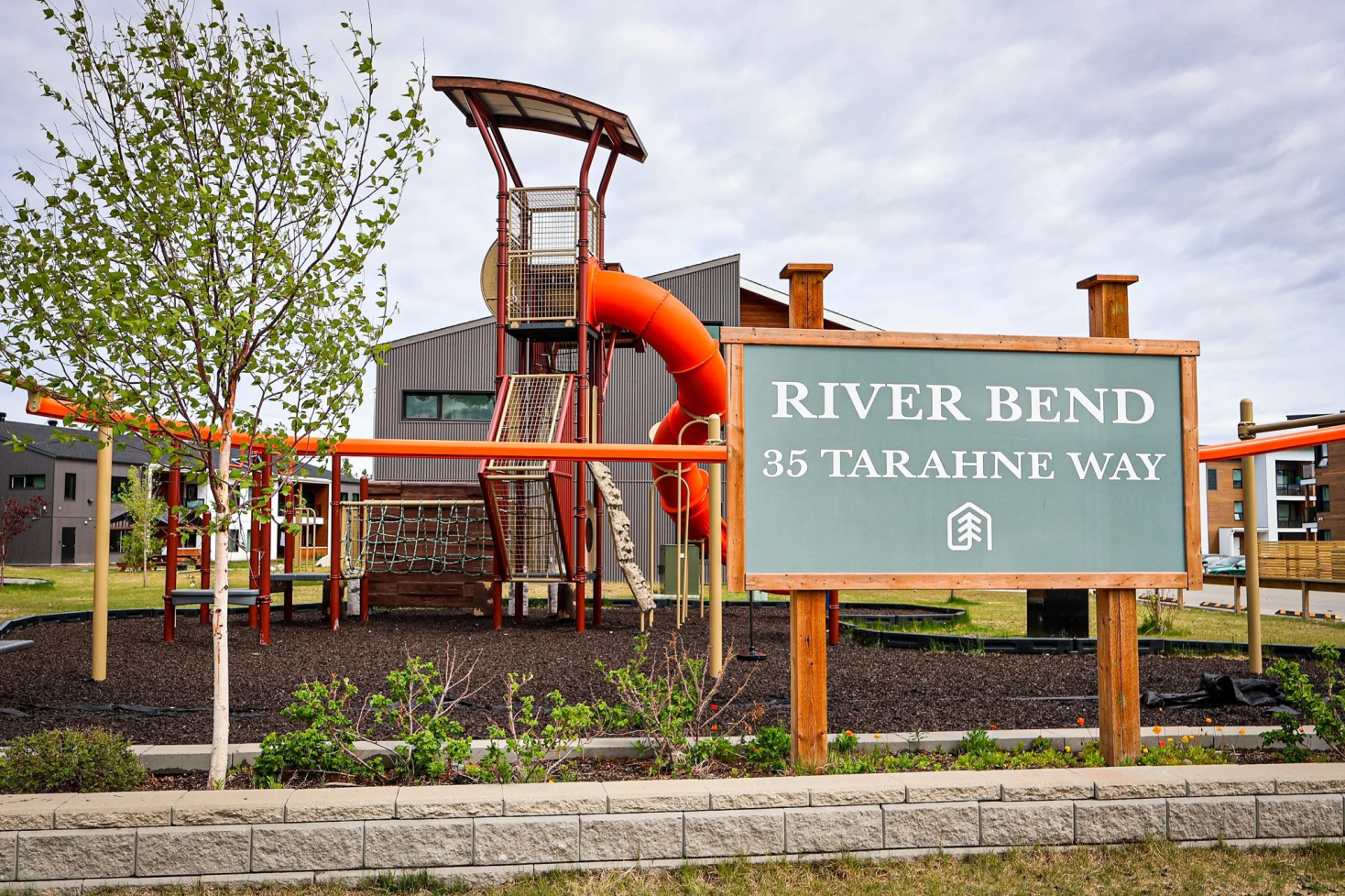 A sign with an address on it in front of a playground
